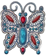 A piece of art with a beautiful butterfly of stamped silver, embellished with turquoise and coral in the Southwestern Native American style, created with a high degree of realism. This design is sure to bring compliments!