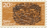 The Maori are known for their facial tattoos. This New Zealand stamp has a facial tattoo on a dark orange background. These shirts have a lightly distressed look for an aged appearance.